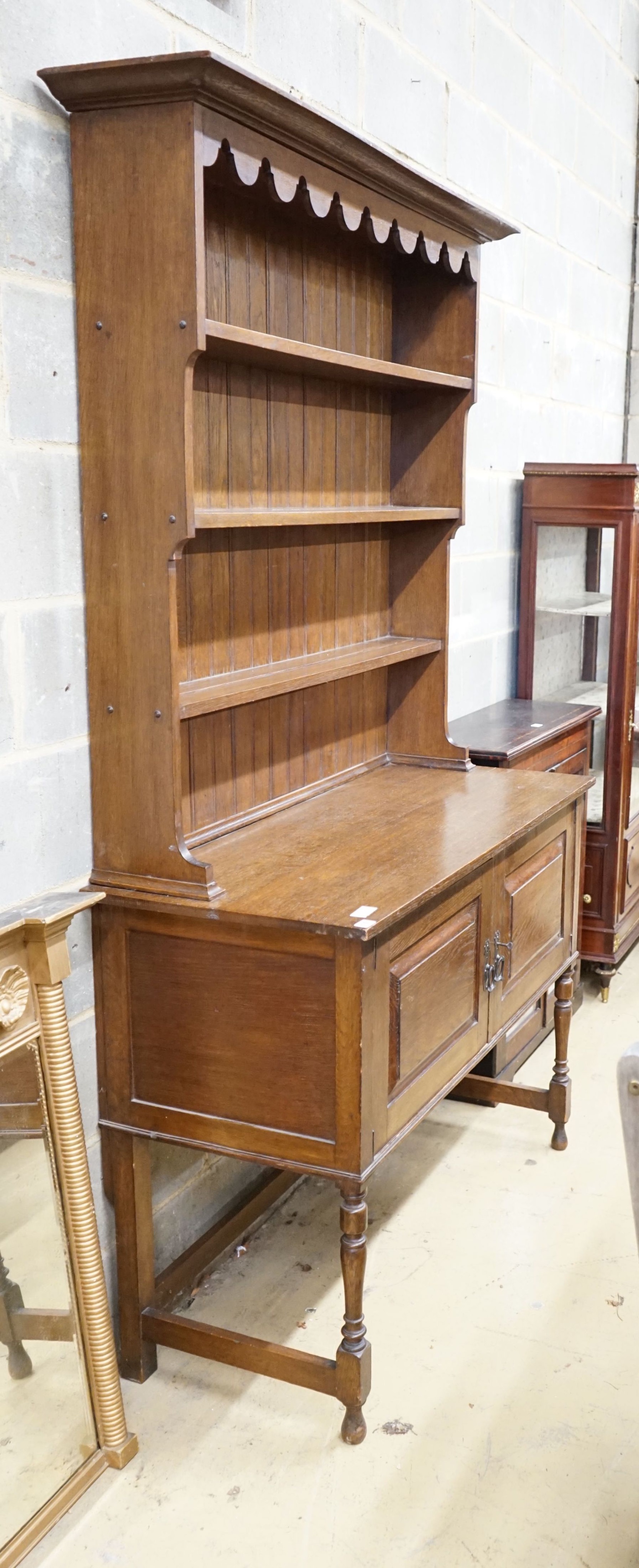 A 1920's oak dresser and plate rack, width 122cm, depth 51cm, height 211cm